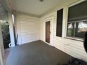 Covered front porch with siding, painted columns, and an inviting entry door at 5121 Newark Ave, Clarkdale, GA 30111