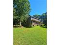 Spacious backyard with lush green lawn and mature trees at 4449 Inns Brook Dr, Snellville, GA 30039