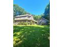 Two-story home featuring a covered front porch and large lawn at 4449 Inns Brook Dr, Snellville, GA 30039