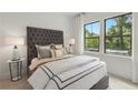 Spacious bedroom with a tufted headboard and large windows at 1084 Battery Park Rd, Decatur, GA 30033