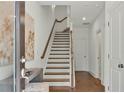 Modern staircase with light wood and white risers in a bright entryway at 1084 Battery Park Rd, Decatur, GA 30033