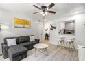 Comfortable living room boasts a gray sofa, modern decor, and an open view into the dining area at 1225 Church St # O, Decatur, GA 30030