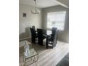 Simple dining room with four chairs and a glass-top table at 2511 Pine Tree Trl, Atlanta, GA 30349