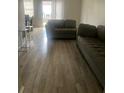 Living room featuring light gray sectional sofa and wood-look floors at 2511 Pine Tree Trl, Atlanta, GA 30349