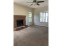 Bright living room featuring a brick fireplace and neutral carpeting at 3103 Snapfinger Ln, Decatur, GA 30034