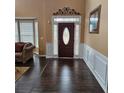 Elegant entryway with dark hardwood floors and a decorative door at 7413 Melhana Ln, Union City, GA 30291