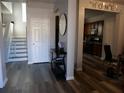 Bright entryway with hardwood floors, leading to kitchen and staircase at 6053 Hemperly Rd, Atlanta, GA 30349