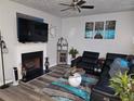 Living room with fireplace, sectional sofa, and hardwood floors at 6053 Hemperly Rd, Atlanta, GA 30349