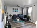 Spacious living room with gray walls, L-shaped sofa, and large TV at 6053 Hemperly Rd, Atlanta, GA 30349