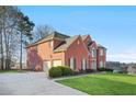 Brick home with a two-car garage and manicured lawn at 4740 Eagles Ridge Loop, Stonecrest, GA 30038