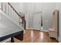 Inviting foyer showcasing hardwood flooring, a staircase, and natural light at 1109 Wiley Bridge Rd, Woodstock, GA 30188