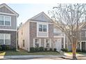 Two-story home with brick and siding, balcony, and landscaping at 875 Venture Sw Way, Atlanta, GA 30331