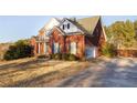 Charming two-story brick home with attached garage and well landscaped front yard at 116 Big Cotton Trl, Mcdonough, GA 30252