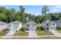 Community of two-story houses with gray and white siding at 1908 Holmsey Se Cir, Conyers, GA 30094