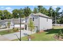 Gray siding two-story home with a two-car garage and neatly landscaped yard at 1908 Holmsey Se Cir, Conyers, GA 30094