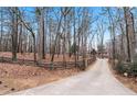 Long driveway leading to a home surrounded by trees at 3355 Old Peachtree Rd, Dacula, GA 30019