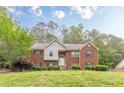 Charming two-story brick home with manicured lawn and inviting entrance at 4671 W Lake Se Dr, Conyers, GA 30094