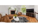 Cozy living room featuring a fireplace and hardwood floors at 1045 Sterling Ridge Chase, Marietta, GA 30062