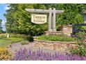 Beautiful stone-framed community sign for Tiberon on the Etowah surrounded by flowers and trees at 7710 Tiberon Pkwy, Cumming, GA 30028