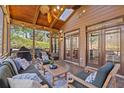 Inviting screened patio with comfortable seating, ceiling fan and wooded view at 96 Grand Ave, Suwanee, GA 30024