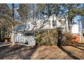 Two-story house with a front porch and mature trees in the yard at 3979 Doral Cir, Atlanta, GA 30360