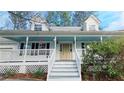 Inviting front porch features painted steps, a light blue ceiling, and charming decor at 3979 Doral Cir, Atlanta, GA 30360