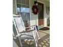 Relaxing front porch with rocking chairs and seasonal decor at 4045 Mark Todd Ct, Hoschton, GA 30548