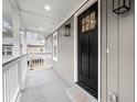 Inviting front porch with white railing and a black front door at 384 Saint Johns Sw Ave, Atlanta, GA 30315