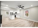 Spacious living room with light flooring, ceiling fan, and kitchen island view at 384 Saint Johns Sw Ave, Atlanta, GA 30315