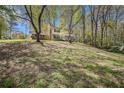 Traditional two-story home with a brick facade and mature trees surrounding the property at 620 Oakstone Way, Roswell, GA 30075