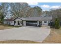 Modern white house with a two-car garage and a covered carport at 97 Grayson New Hope Rd, Grayson, GA 30017