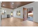 Open living space with wood floors and kitchen access at 1337 Fairfield Dr, Lilburn, GA 30047