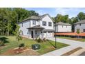 Two-story house with white siding, gray accents, and a two-car garage at 2448 Lenox Se Rd, Conyers, GA 30094