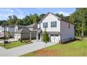 Two-story house with white siding, gray accents, and a two-car garage at 2448 Lenox Se Rd, Conyers, GA 30094
