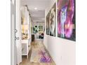 Inviting hallway with bright decor and flower art pieces at 211 Sanctuary Dr, Mcdonough, GA 30253