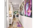 Bright hallway with decor, wooden floors, modern furniture, and contemporary art at 223 Sanctuary Dr, Mcdonough, GA 30253