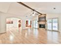 Bright living room featuring a stone fireplace, hardwood floors, and sliding glass doors to the backyard at 1195 Fielding Way, Marietta, GA 30068