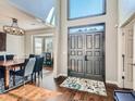 Two-story entryway with hardwood floors, chandelier, and formal dining area at 2575 Wild Iris Ln, Dacula, GA 30019