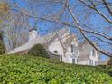 House exterior with mature shrubbery and a tree-lined view at 2575 Wild Iris Ln, Dacula, GA 30019