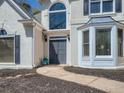 Front entrance with double doors, stone pathway, and bay window at 2575 Wild Iris Ln, Dacula, GA 30019