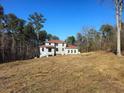 View of two-story home with red roof in construction phase on a large lot at 515 Penny Ln, Loganville, GA 30052