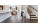 Open-concept kitchen with stainless steel appliances, granite countertops, and hardwood floors at 250 Lytham Se Dr, Mableton, GA 30126