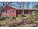 Charming single-Gathering home with a well-maintained lawn, covered front porch, and mature trees at 731 Willow Ridge Dr, Marietta, GA 30068