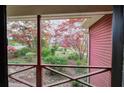 Enjoy the view from the porch, showcasing a serene, landscaped yard with trees and colorful azaleas at 731 Willow Ridge Dr, Marietta, GA 30068
