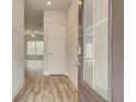 Welcoming entryway showcasing stylish wood-look flooring and a modern door with smart lock at 4311 Portsbrook Ave, Snellville, GA 30039