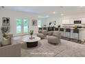 Bright and airy staged living room with modern finishes adjacent to dining and kitchen area at 213 Cottontail Ln, Villa Rica, GA 30180