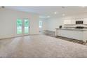 Bright and airy open-concept living room and kitchen with modern finishes and appliances at 213 Cottontail Ln, Villa Rica, GA 30180