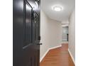 Entryway featuring wood floors, a modern ceiling light and a dark painted front door at 1280 W Peachtree Nw St # 3009, Atlanta, GA 30309