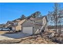 Two-story house with brick and siding, attached garage, and a driveway at 6292 Hickory Lane Cir, Union City, GA 30291