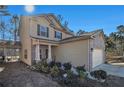 Two-story house with a brick and siding exterior, attached garage, and landscaping at 6292 Hickory Lane Cir, Union City, GA 30291